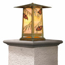  Pacific Grove column mount lantern with verdigris finish. Features Asian-inspired pagoda roof and glowing orange glass panels with monarch butterflies and eucalyptus leaves in Arts & Crafts style.