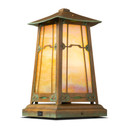  A playful, pedestal mounted table lantern with colorful accent glass, a cloud lift overlay pattern, aged patina finish and iridescent glass.