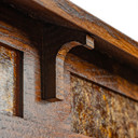  Architectural detail of Craftsman lamp bracket showing quarter-sawn oak joinery and traditional woodworking techniques. Arts & Crafts lighting hardware featuring period-appropriate construction and historically-inspired design elements.