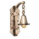  Tudor Revival wall sconce with curved pewter arm and lantern-style shade featuring hand-hammered texture and geometric detailing. English Arts & Crafts lighting with historically-inspired metalwork and warm Edison bulb illumination.