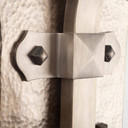  Close-up of hammered pewter sconce bracket showing geometric pyramid detailing and traditional metalwork techniques. English Arts & Crafts lighting hardware featuring period-perfect finish and architectural heritage craftsmanship.