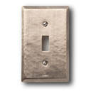  A hammered brass, single toggle switch plate cover with a glossy pewter or nickel finish.