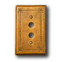  A hammered brass, push-button switch plate cover with a warm patina finish.