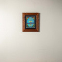  A vibrant artwork by Julie Leidel featuring a solitary tree with a vibrant yellow canopy on a rocky island in serene water, its reflection creating symmetry, backed by deep blue and purple silhouetted mountains, with the quote 