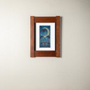 An archival print of a bat and crescent moon in a mortise and tenon oak frame and soft white mat.