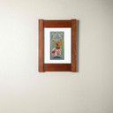   An archival art print of a monarch butterfly on pink flowers. It has a white mat and mortise and tenon oak frame.