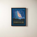  A canvas print of the Milky Way rising over a forest. It's in a brown float frame.