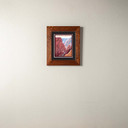  An archival print of a painting of a canyon and river. It has a double mat in a 2