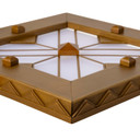  Corner detail view of a square can or recessed light cover with a stepped pyramid pattern and filigree in an antique brass finish.