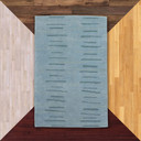 A Modern-era style graphics rug with a soft, seafoam or aquamarine blue field. 