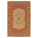 A busy and bold wool rug in a rich, warm color palette featuring a myriad of geometric graphic elements. 