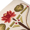  Closeup photo of a linen beige throw pillow featuring embroidered artwork of a red waterlily and green leaves.