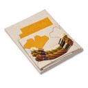  DIY embroidery kit for a gingko pillow design, showing folded natural linen stamped with a gingko alongside arranged embroidery thread skeins in beige, copper, rust and olive green.