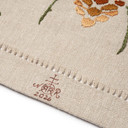  Close-up of brown Roycrofters maker's monogram mark and date on natural linen fabric pine cone table scarf.