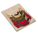  DIY embroidery kit for a poppies table scarf design, showing folded natural linen stamped with a poppies alongside arranged embroidery thread skeins in a variety of colors.