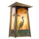  A flush mounted, art nouveau wall sconce light with an aged patina finish, golden glass and a blue heron filigree.