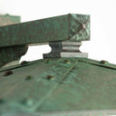  Detail of a rustic, artistic wall mounted light fixture with Japanese Maple artwork, an aged verdigris finish and golden glass.