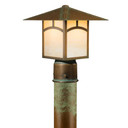  A linear, formal Craftsman lantern with an aging patina finish and warm glass on a brass post. This Arts & Crafts fixture has window pattern artwork on the body.