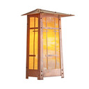  A vertical, linear Arts & Crafts flush mounted wall sconce light fixture with horizontal metal accents with a raw copper finish and warm, glowing glass.
