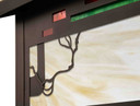  Detail of a horizontal brass blacker house mailbox with an bronze finish and warm toned glass with red and green accents.