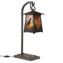  A beefy, rustic table lamp on a hooked arm with hammered metal artwork of California Quail, an oil-rubbed bronze finish and illuminated mica panels instead of glass.