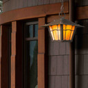  An authentic reproduction of the chain mounted outdoor lantern at the Gamble House in Pasadena, California. The fixture has an oil rubbed bronze finish, golden glass and hangs in front of a Craftsman style home near mountains.
