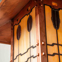  Body corner detail from an authentic reproduction of backyard patio column landscaping lantern at the Gamble House in Pasadena, California.The pier mounted fixture has a raw copper finish and custom glasswork.