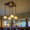  A four light chandelier with a tapered ceiling plate installed in a historic Craftsman bungalow. This fixture was custom designed for one of Brett Waterman's televised home restorations.