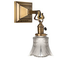  A reproduction of a Craftsman style 1910s wall mounted sconce lantern with an aged brass finish, a turn key socket and decorative, translucent white shade.