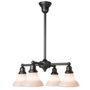 A reproduction Craftsman style bungalow chandelier light fixture with four lights on linear stems. It has a satin black finish and vase-shaped, milky-white glass shades. The lanterns are aimed downward.