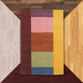  A contemporary, hand-knotted wool rug featuring a bold, asymmetric color-block design in a vibrant rainbow palette. The rug is composed of large, solid rectangular sections in burgundy, mustard yellow, dusty pink, burnt orange, sage green, and navy blue.