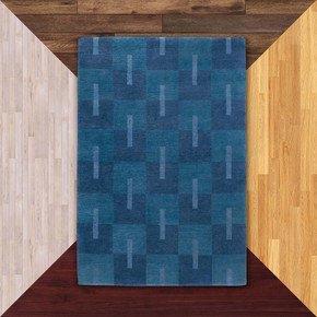  A checkerboard Scandinavian style Mid-Century wool rug in a deep aquatic palette. It's on a background of floor color samples.