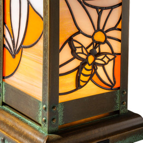  Illuminated details of a stained glass panel on a cordless table lamp inspired by Japanese architecture.