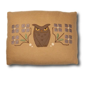  Warm tan fabric pillow with a central embroidered brown owl motif with yellow eyes.