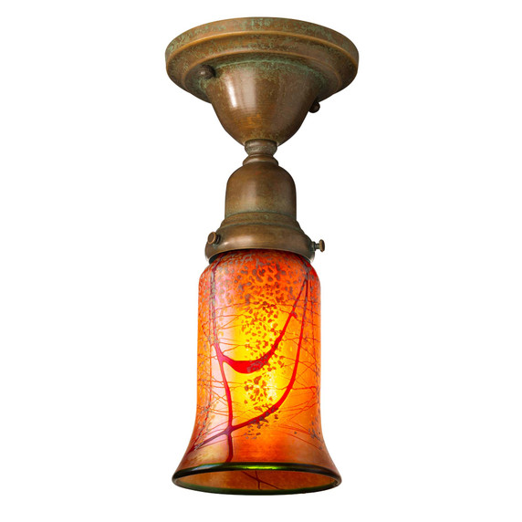  A traditional, Victorian transitional Craftsman style ceiling light fixture with a patina finish and an illuminated, trumpet-shaped blown glass shade with a cherry blossom design.