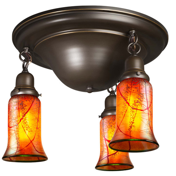 A traditional, Victorian or transitional Craftsman style ceiling light fixture with an oil rubbed bronze finish and three hanging lanterns. The lanterns have illuminated, trumpet shaped blown glass shades with a cherry blossom design.