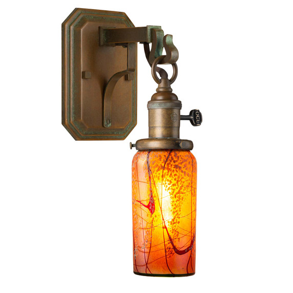  A reproduction of an antique Craftsman wall sconce light fixture with a metal corbel and hook mount for the lantern, which has a turn key socket, aged patina finish and an illuminated, cylindrical cherry blossom blown glass shade.