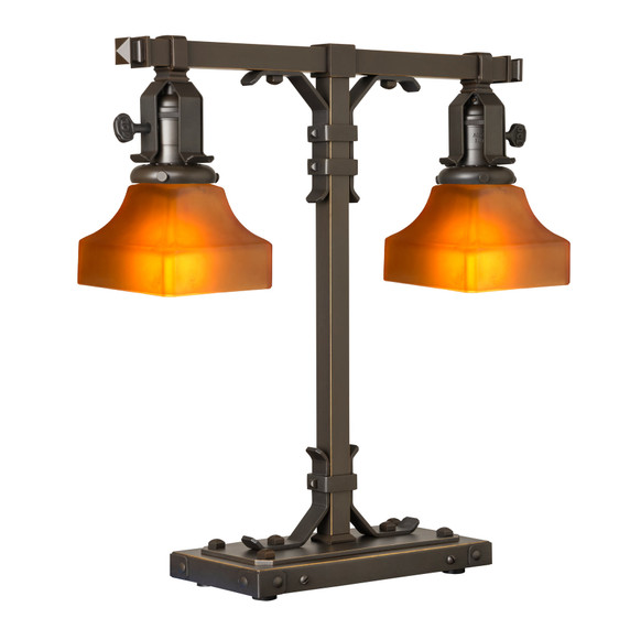  A stout and burly Arts & Crafts or Craftsman table lamp with an oil rubbed bronze finish and tapered, orange glass shades.