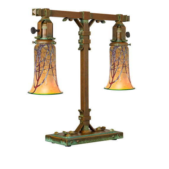  A stout and burly Arts & Crafts or Craftsman table lamp with an aged patina finish and tapered, cherry blossom blown glass shades.