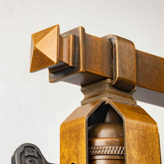  Finial detail from a stout and burly Arts & Crafts or Craftsman table lamp with an aged finish.