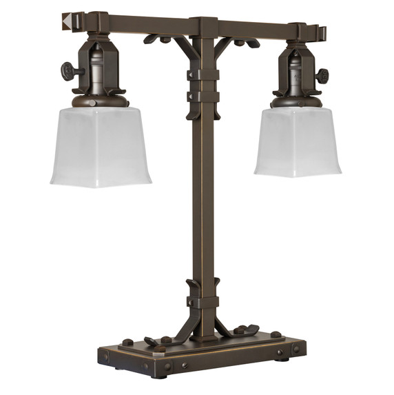  A stout and burly Arts & Crafts or Craftsman table lamp with an oil rubbed bronze finish and rectangular, white glass shades.