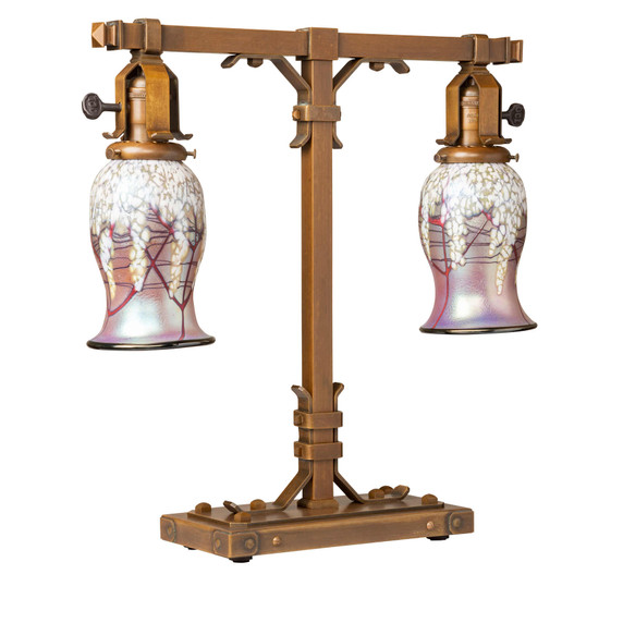  A stout and burly Arts & Crafts or Craftsman table lamp with an aged finish and curvy, cherry blossom blown glass shades.