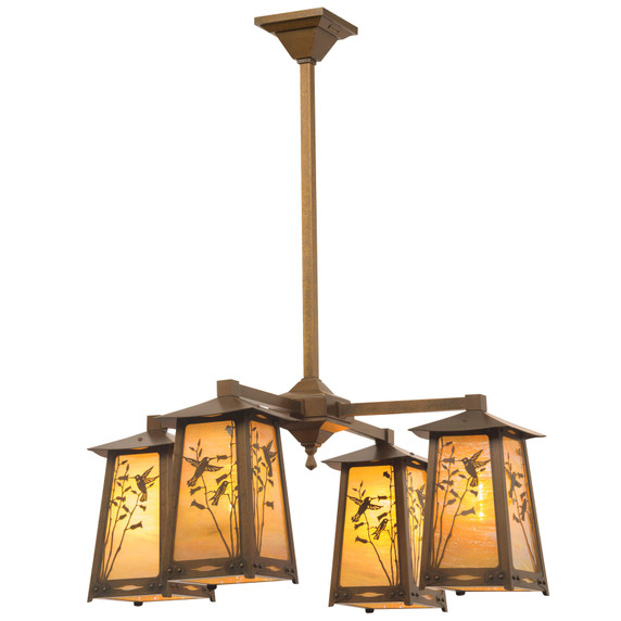  An art nouveau chandelier with four lanterns on linear arms. The lanterns feature hummingbird artwork, an aged finish and golden glass.