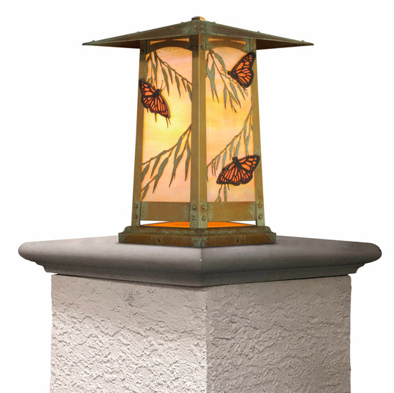  Pacific Grove column mount lantern with verdigris finish. Features Asian-inspired pagoda roof and glowing orange glass panels with monarch butterflies and eucalyptus leaves in Arts & Crafts style.