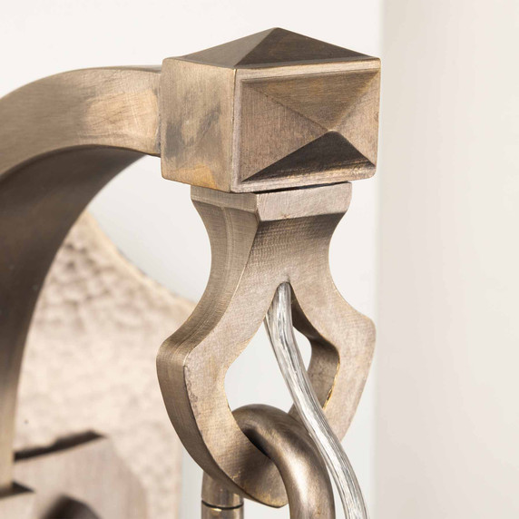  Architectural detail of Tudor Revival sconce bracket with geometric pyramid accent and hand-forged pewter construction. Spanish Revival lighting featuring traditional metalwork and period-appropriate decorative elements.