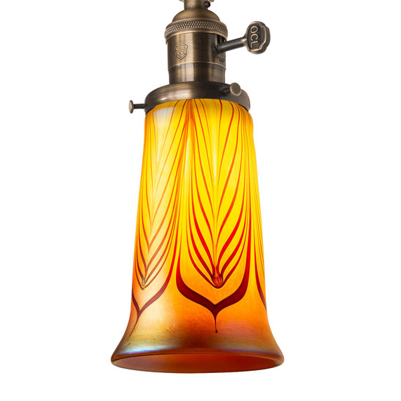  An illuminated, fluted red feather blown glass shade. 