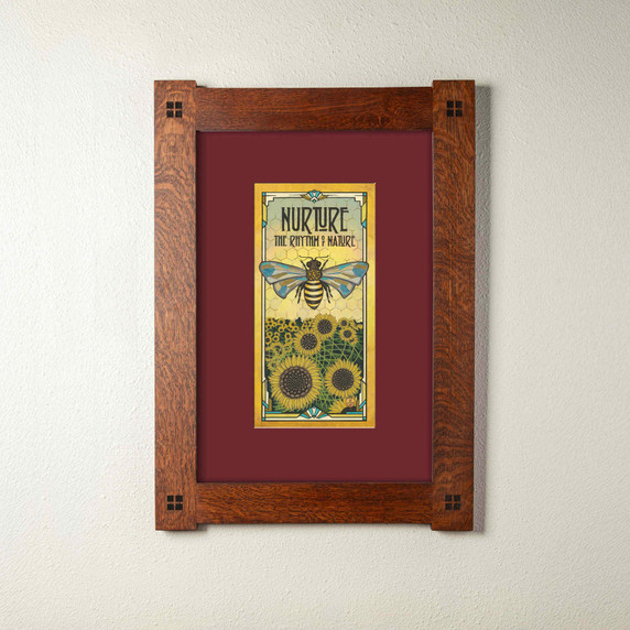  An archival print of a bee with sunflowers. It has a maroon mat and foursquare oak frame.