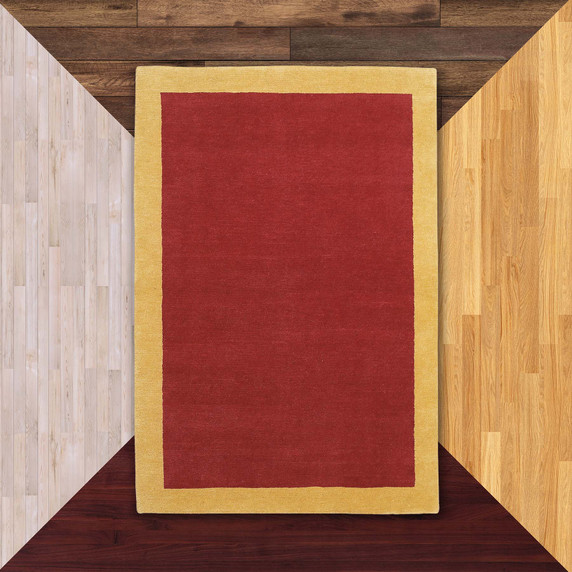  A Modern or contemporary styled rug with a solid red body and bold yellow border set against floor color samples.