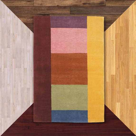 A contemporary, hand-knotted wool rug featuring a bold, asymmetric color-block design in a vibrant rainbow palette. The rug is composed of large, solid rectangular sections in burgundy, mustard yellow, dusty pink, burnt orange, sage green, and navy blue.