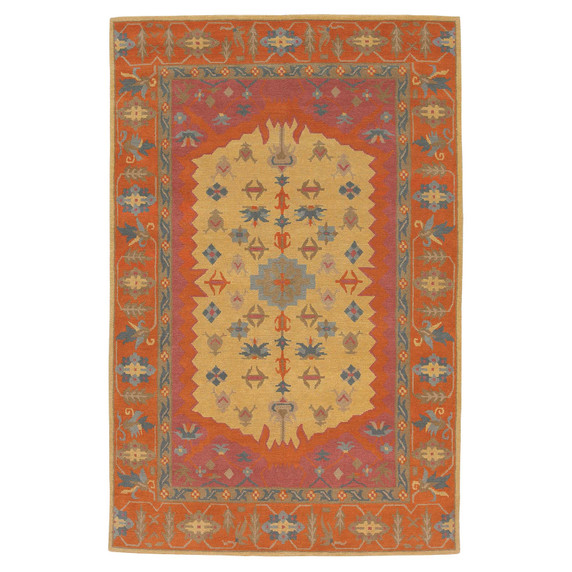 A busy and bold wool rug in a rich, warm color palette featuring a myriad of geometric graphic elements. 
